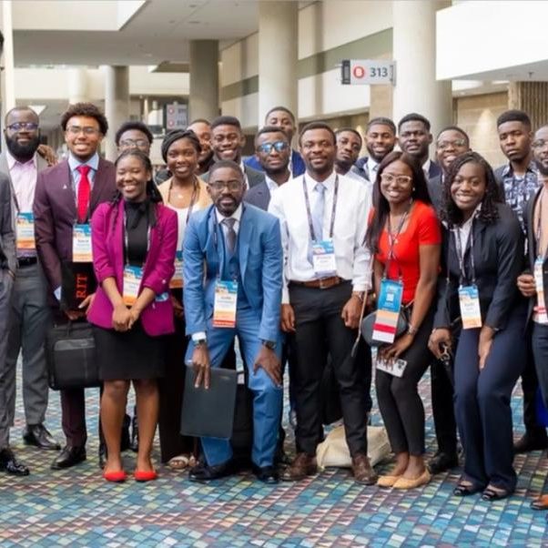 A large group of African students and professionals at a conference